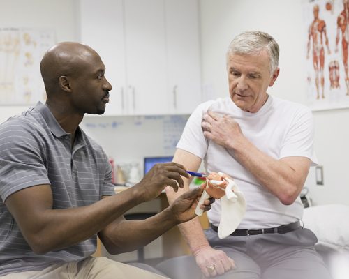 A physical therapist explaining to a patient using a model to describe his shoulder pain. Due to the demands of an aging population, many surveys of fast-growing professions rank physical therapy high on the list. The median salary is $75,000, and the U.S. Bureau of Labor Statistics forecasts a sizzling 39 percent growth rate in the coming decade. Only clergy and firefighters scored higher in job satisfaction.